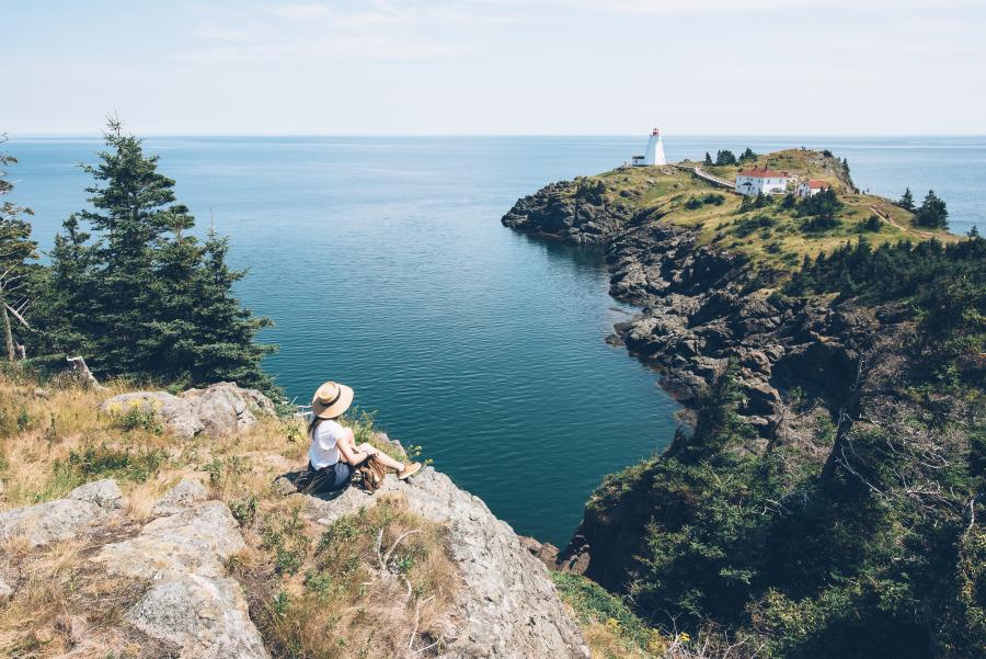 a girl looking at the cliff view on grand manan
