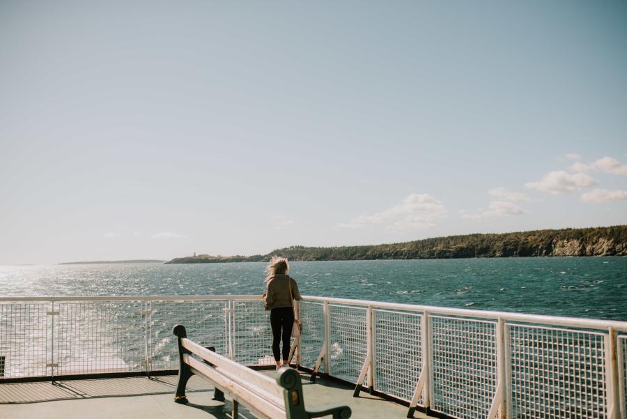 a woman looking out at the water on the grand manan ferry