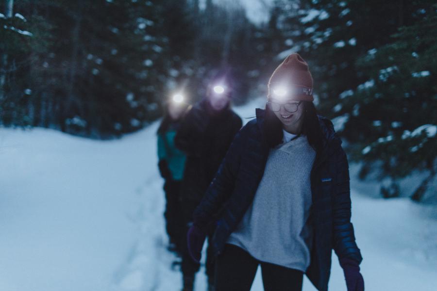3 girls hiking in the winter at night