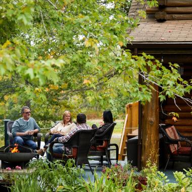 people sitting around a fire at ledges inn