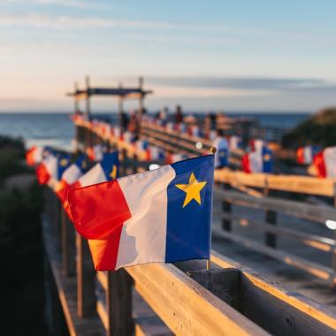 Acadian flags on seaside boardwalk