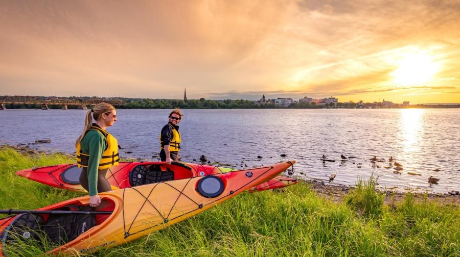 two people with kayaks