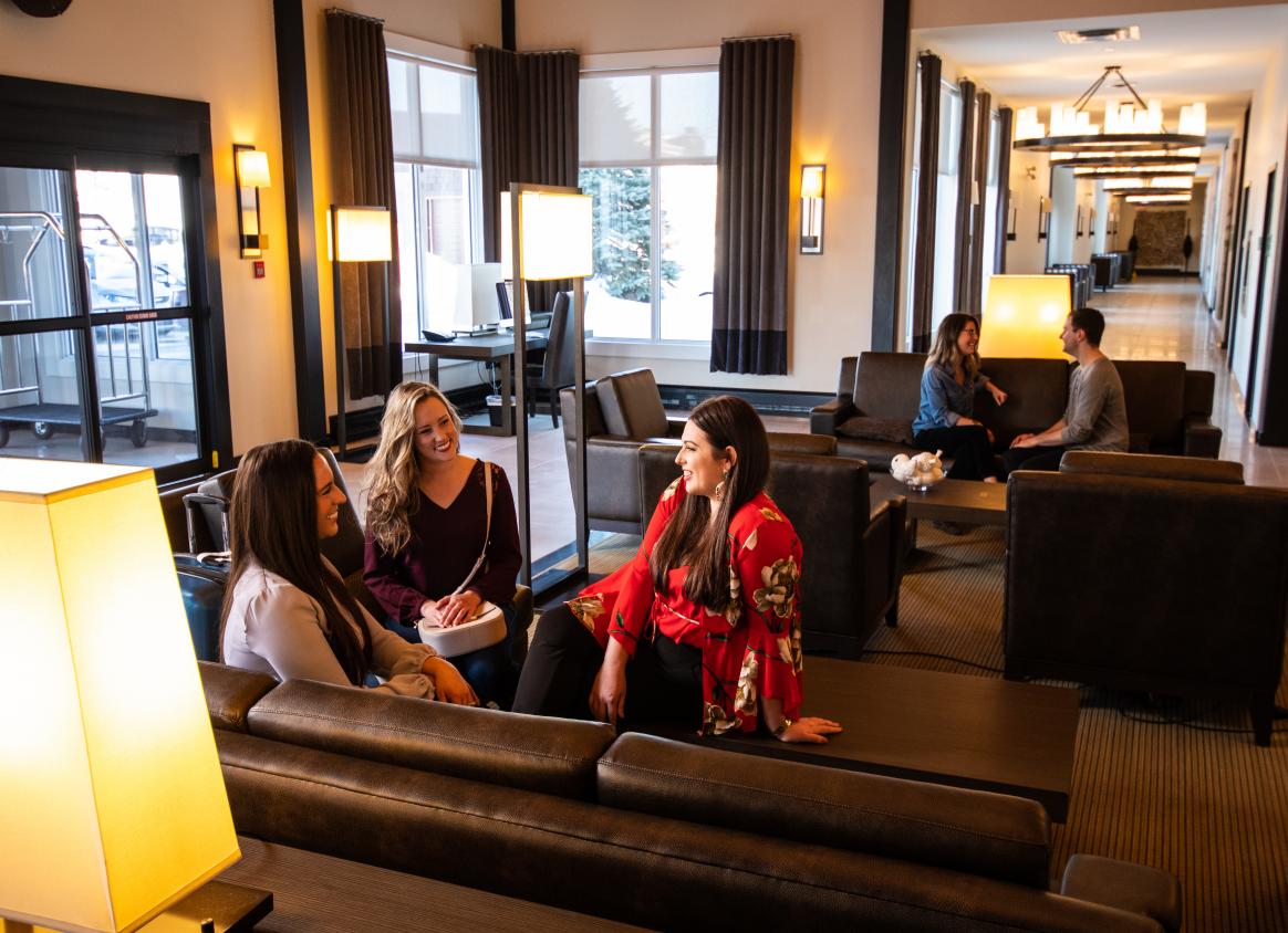A group of women sitting in the lobby of a hotel